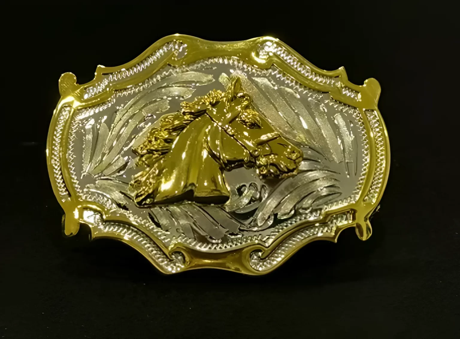 A cowboy buckle with a horse on it.
