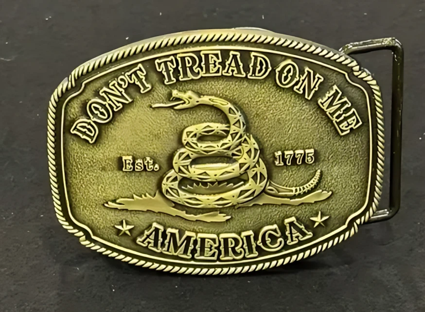 A silver belt buckle with a snake on it.
