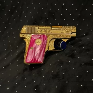 Gold Colt 1903 custom firearm with floral engravings and pink pearl-patterned grips.