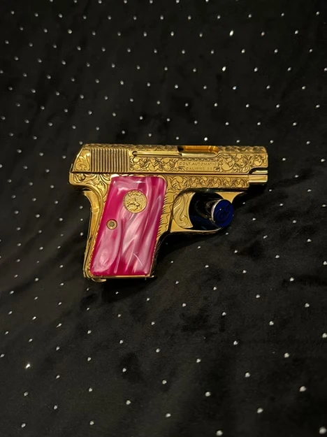 Colt 1908 pistol featuring pink pearl grips and 24K gold-plated accents