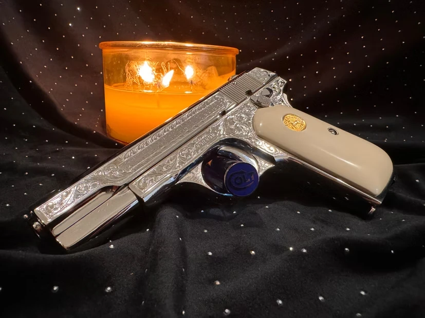 A silver gun with engravings 