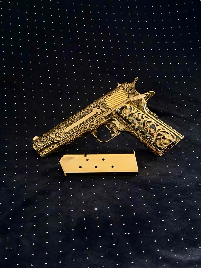 A firearm with a lustrous 24K gold electroplated finish and ornate gold-lace grips.