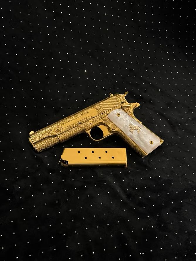 A 24K gold electroplated firearm featuring elegant pearl grips