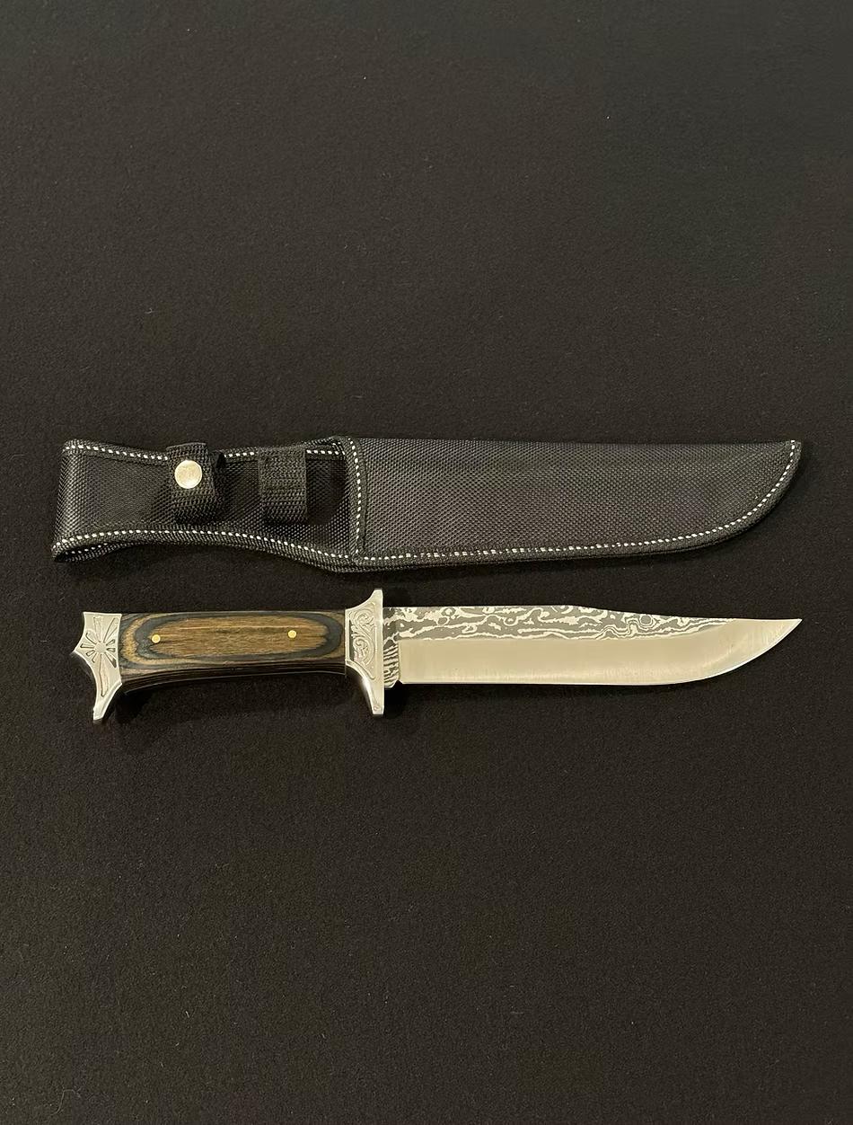 A rugged Bowie knife, with a durable handle and a sharp, versatile blade.