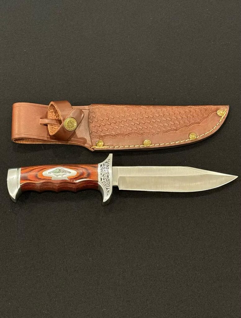 A classic Bowie knife with a large blade, clip point, and a sturdy handle.