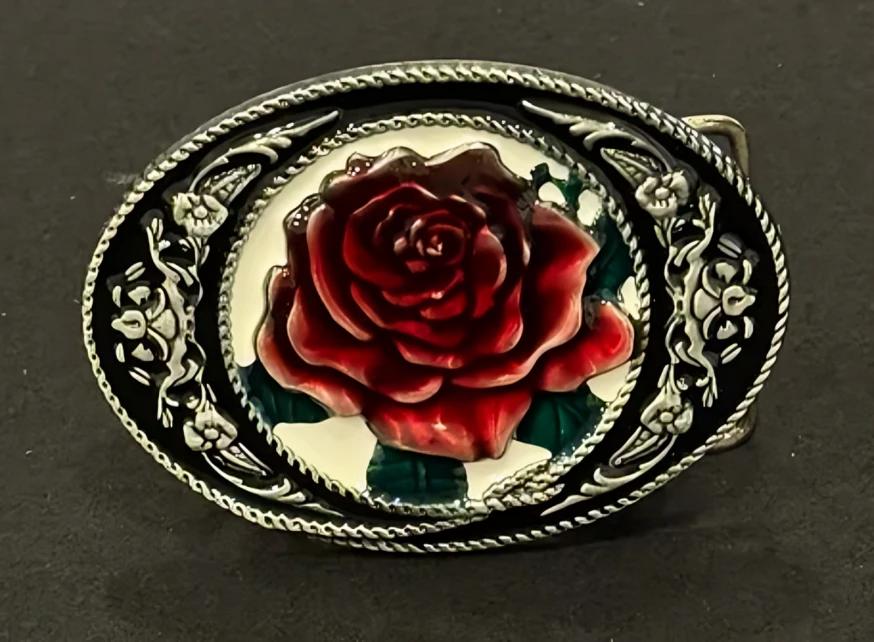 A belt buckle with a rose on it.