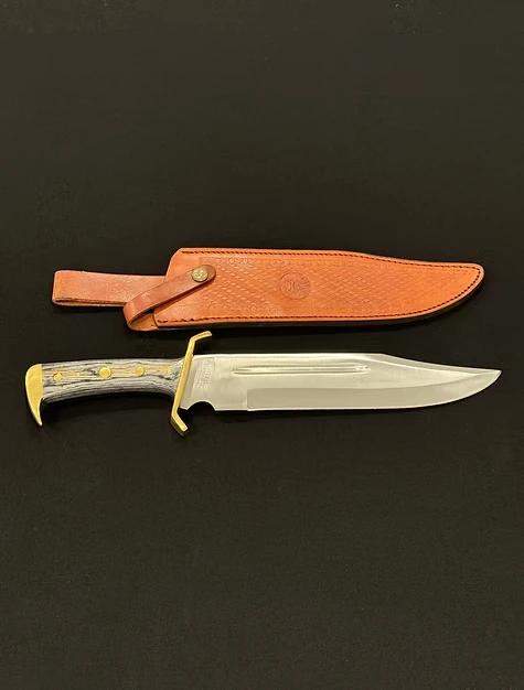A Bowie knife with a handle.