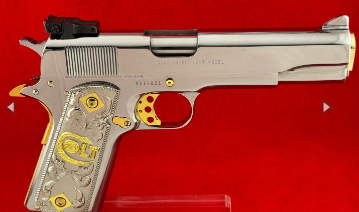 A silver and god engraved gun