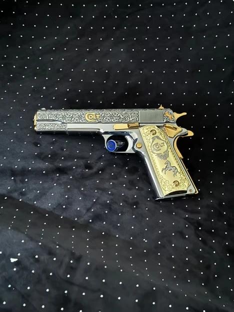 A gun with gold grips.