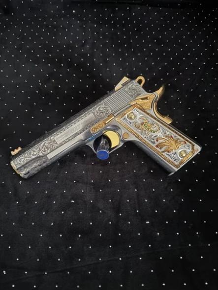 Handgun grip with textured surface shown in a close-up product photo
