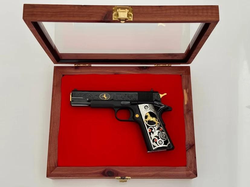 High-end gun display case showcasing a collectible firearm in a premium presentation setting