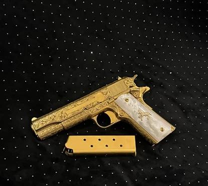 Colt handgun featuring a premium 24K gold finish with elegant white pearl grips