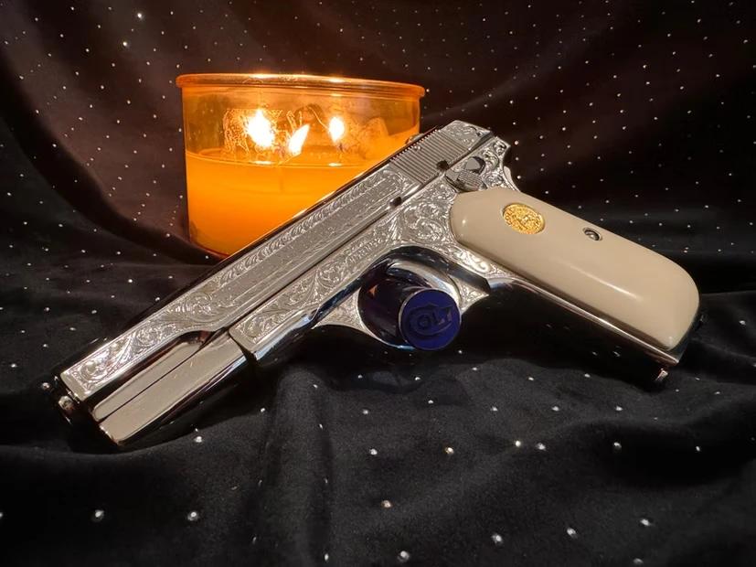 Colt 32mm featuring hand engraving, nickel plating, and a giraffe bone grip